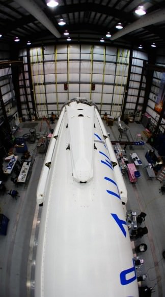 All four landing legs now mounted on Falcon 9 rocket being processed inside hanger at Cape Canaveral, FL for Mar 16 launch.  Credit: SpaceX/Elon Musk