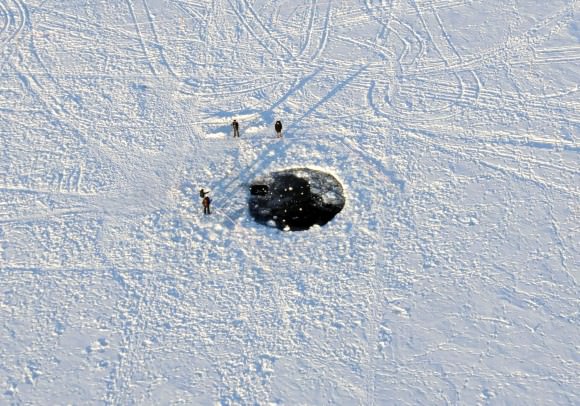 The 26-foot-wide (8-meter) hole punched in the ice of Chebarkul Lake by the largest fragment of the Chelyabinsk meteorite. Credit: Eduard Kalinin
