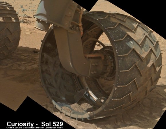 Up close photomosaic view shows lengthy tear in rover Curiosity’s left front wheel caused by recent driving over sharp edged Martian rocks on the months long trek to Mount Sharp. Raw images taken by the MAHLI camera on Curiosity’s arm on Jan. 31, 2014 (Sol 529) were assembled to show some recent damage to several of its six wheels   Credit: NASA / JPL / MSSS / Marco Di Lorenzo / Ken Kremer- kenkremer.com  See below complete 6 wheel mosaic and further wheel mosaics for comparison