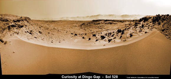 Curiosity’s View Past Tall Dune at edge of ‘Dingo Gap’  This photomosaic from Curiosity’s Navigation Camera (Navcam) taken at the edge of the entrance to the Dingo Gap shows a 3 foot (1 meter) tall dune and valley terrain beyond to the west, all dramatically back dropped by eroded rim of Gale Crater. View from the rover’s current position on Sol 528 (Jan. 30, 2014). The rover team may decide soon whether Curiosity will bridge the dune gap as a smoother path to next science destination. Credit: NASA/JPL-Caltech/Marco Di Lorenzo/Ken Kremer- kenkremer.com