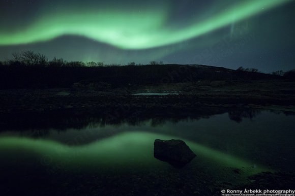   Aurora reflects on water, as seen  on February 20, 2014 near Bremnes, Troms Fylke, Norway. Credit and copyright: Ronny Årbekk. 