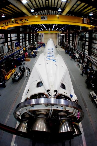 The Falcon 9 rocket with landing legs in SpaceX’s hangar at Cape Canaveral, Fl, preparing to launch Dragon to the space station this Sunday March 30.  Credit: SpaceX