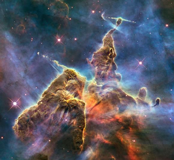 This Hubble photo is of a small portion of one of the largest seen star-birth regions in the galaxy, the Carina Nebula. Towers of cool hydrogen laced with dust rise from the wall of the nebula. Credit: NASA, ESA, and M. Livio and the Hubble 20th Anniversary Team (STScI).