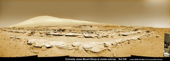 Mars rock rows and Mount Sharp. Martian landscape scene with rows of striated rocks in the foreground and Mount Sharp on the horizon. NASA's Curiosity Mars rover paused mid drive at the Junda outcrop to snap the component images for this navcam camera photomosaic on Sol 548 (Feb. 19, 2014) and then continued traveling southwards towards mountain base.   UHF Antenna at right. Credit: NASA/JPL-Caltech/Marco Di Lorenzo/Ken Kremer-kenkremer.com