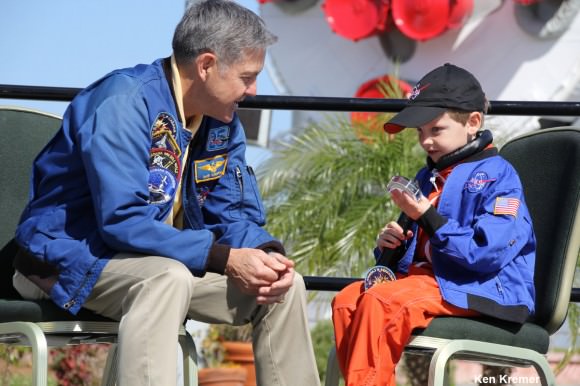 Connor Johnson, 6, talks with former space shuttle commander Bob Cabana, director of Kennedy Space Center, about spaceflight during a ceremony Saturday, March 15, at the Kennedy Space Center Visitor Complex. Connor holds the ISS bolt given to him by Cabana in appreciation of Connor initiating a petition to the White House to maintain NASA funding.  Credit: Ken Kremer - kenkremer.com