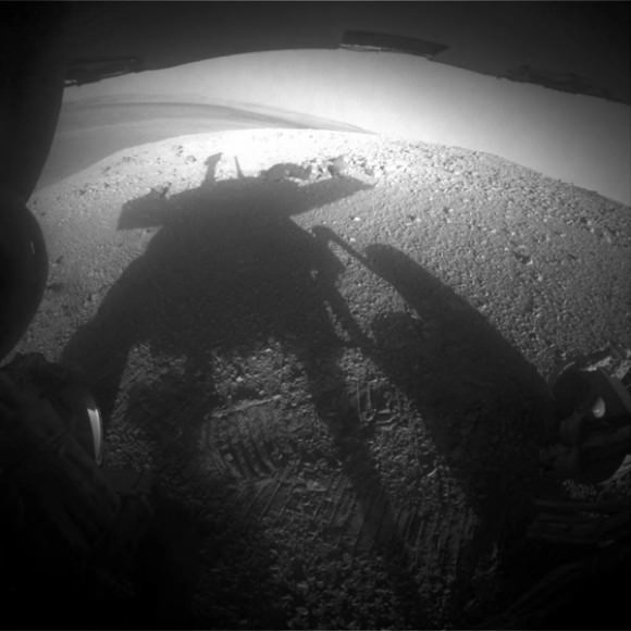 Late afternoon lighting produced a dramatic shadow of NASA's Mars Exploration Rover Opportunity photographed by the rover's rear hazard-avoidance camera on March 20, 2014. Credit: NASA/JPL-Caltech/Cornell Univ./Arizona State Univ.