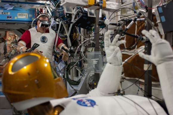 NASA Expedition 35 astronaut Tom Marshburn (background) performs teleoperation activitites with Robonaut 2 aboard the International Space Station in 2013. Credit: NASA