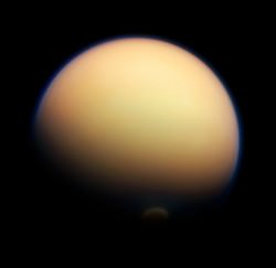 Titan's surface is almost completely hidden from view by its thick orange "smog" (NASA/JPL-Caltech/SSI. Composite by J. Major)