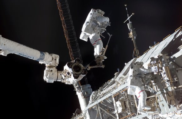 Expedition 15's Clay Anderson (on Canadarm2) and STS-118's Rick Mastracchio (right) during an August 2007 maintenance spacewalk on the International Space Station. The NASA astronauts relocated an S-Band antenna subassembly, installed a new transponder and retrieved another transponder. Credit: NASA