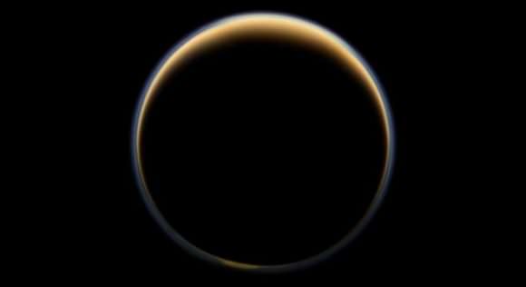 ASA's Cassini spacecraft looks toward the night side of Saturn's largest moon and sees sunlight scattering through the periphery of Titan's atmosphere and forming a ring of color. Credit: NASA/JPL-Caltech/Space Science Institute 