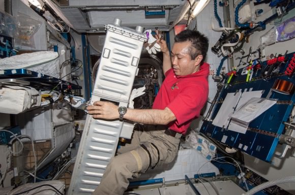 Expedition 39 commander Koichi Wakata performs maintenance on the Carbon Dioxide Removal Assembly on the International Space Station. Picture taken in April 2014. Credit: NASA