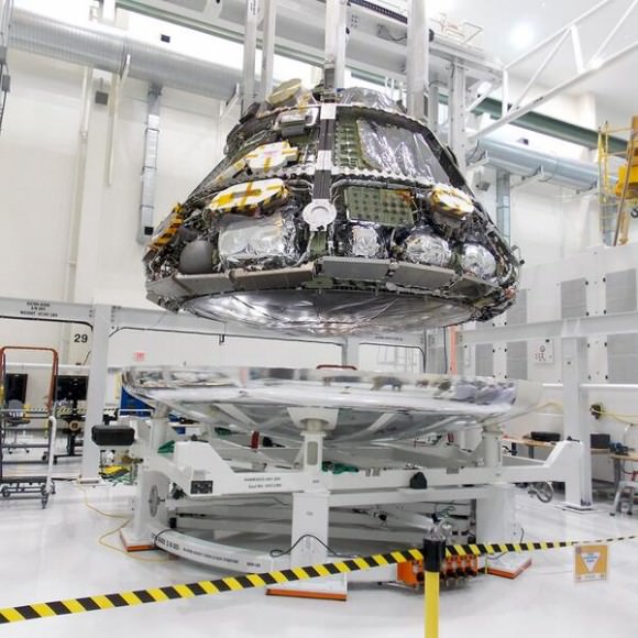 Coming together! Orion's heat shield and crew module in position for mating operations at NASA KSC. Credit: NASA