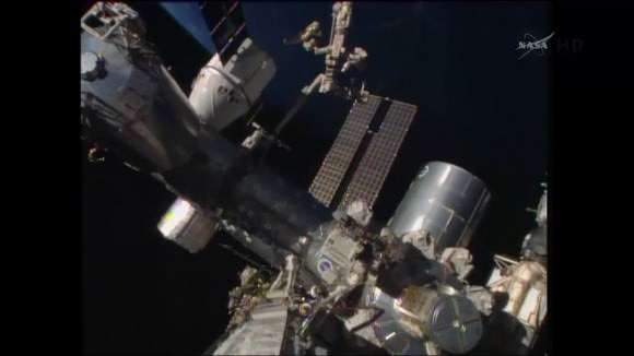Canada’s Dextre manipulator attached to Canadarm2 conducts external cargo transfers from the SpaceX Dragon resupply ship.  Credit: NASA TV