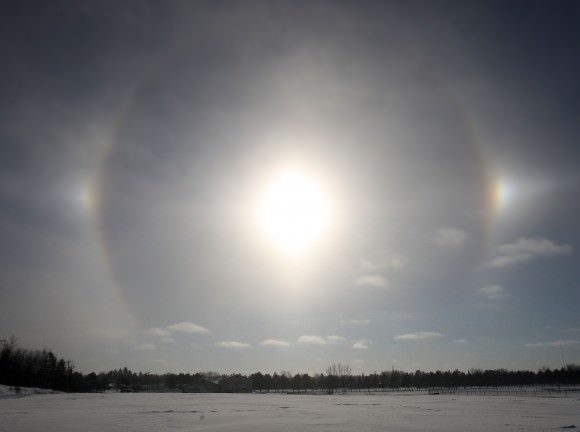 The sun on Dec. 6, 2013 with a 22-degree halo and two luminous canine companions or sundogs. Credit: Bob King
