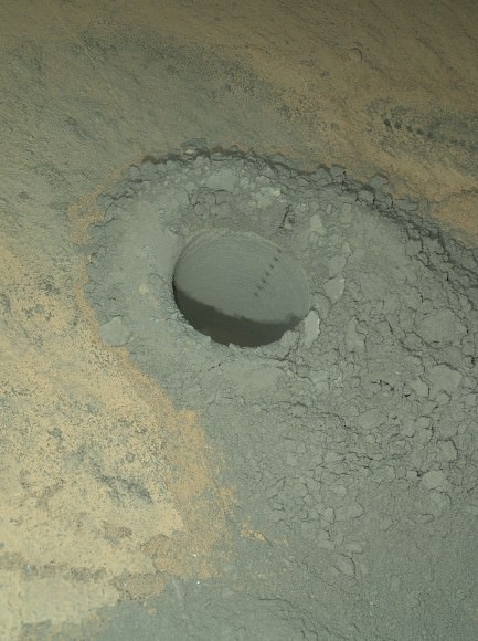 The Mars Hand Lens Imager on NASA's Curiosity Mars rover provided this nighttime view of a hole produced by the rover's drill and, inside the hole, a line of scars produced by the rover's rock-zapping laser. The hole is 0.63 inch (1.6 centimeters) in diameter.  The camera used its own white-light LEDs to illuminate the scene on May 13, 2014.  Credit:  NASA/JPL-Caltech/MSSS