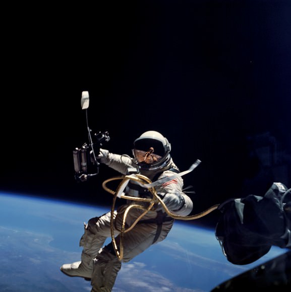 Attached by a tether, Gemini 4 astronaut Ed White tests out spacewalking June 4, 1965. Credit: NASA