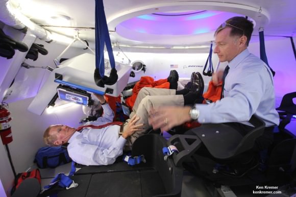 US Senator Bill Nelson (FL) and NASA’s final space shuttle commander inside Boeing’s CST-100 manned capsule during unveiling ceremony at the Kennedy Space Center, Florida on June 9, 2014.  Nelson is seated below pilots console and receives CST-100 briefing from Ferguson who now directs Boeing’s crew efforts.  Nelson also flew in space aboard the Columbia shuttle in Jan. 1986.  Credit: Ken Kremer - kenkremer.com