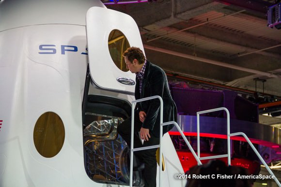 SpaceX CEO Elon Musk pulls open the hatch to ;Enter the Dragon’.    Credit:  Robert Fisher/America Space