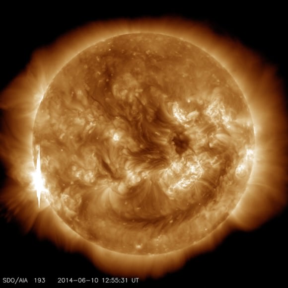 The second X-class flare of June 10, 2014, appears as a bright flash on the left side of this image from NASA’s Solar Dynamics Observatory. This image shows light in the 193-angstrom wavelength, which is typically colorized in yellow. It was captured at 8:55 a.m EDT, just after the flare peaked. Image Credit: NASA/SDO.