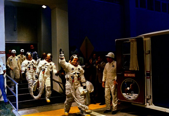 Beginning the Mission. The Apollo 11 crew leaves Kennedy Space Center's Manned Spacecraft Operations Building during the pre-launch countdown. Mission commander Neil Armstrong, command module pilot Michael Collins, and lunar module pilot Buzz Aldrin prepare to ride the special transport van to Launch Complex 39A where their spacecraft awaited them. Liftoff occurred 38 years ago today at 9:32 a.m. EDT, July 16, 1969.  Image credit: NASA 