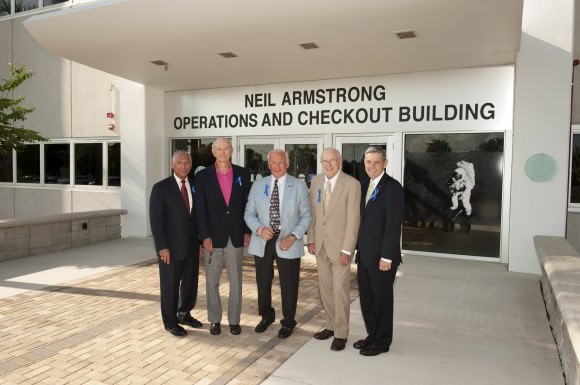 At the Kennedy Space Center in Florida on July 21, 2014, NASA officials and Apollo astronauts have a group portrait taken in front of the refurbished Operations and Checkout Building, newly named for Apollo 11 astronaut Neil Armstrong, the first person to set foot on the moon. From left are NASA Administrator Charles Bolden, Apollo astronauts Mike Collins, Buzz Aldrin and Jim Lovell, and Center Director Robert Cabana. The visit of the former astronauts was part of NASA's 45th anniversary celebration of the Apollo 11 moon landing. The building's high bay is being used to support the agency's new Orion spacecraft, which will lift off atop the Space Launch System rocket. Photo credit: NASA/Kevin O'Connell