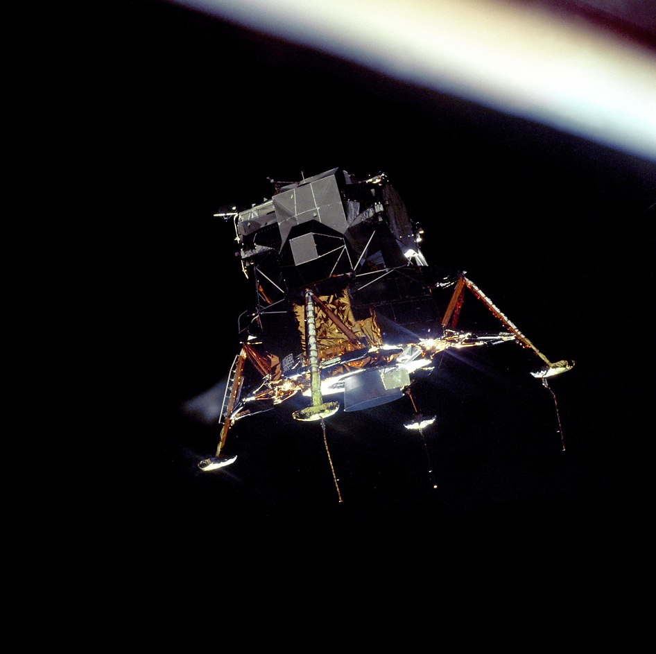 Apollo 11's Columbia Module photographed the Lunar Module Eagle in a landing configuration. The long rod-like protrusions under the landing pods are lunar surface sensing probes. Upon contact with the lunar surface, the probes sent a signal to the crew to shut down the descent engine. Image Credit: NASA