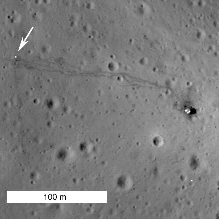 The Apollo 14 landing site imaged by the Lunar Reconnaissance Orbiter in 2011. At right is the descent stage of Antares, the lunar module. At far left, beside the cart tracks and marked by an arrow, is the Apollo Lunar Surface Experiment Package. Credit: NASA/GSFC/Arizona State University