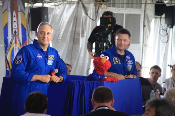 NASA astronauts Mike Massimino (left) and Douglas Wheelock flank Elmo during a NASA tweetup in July 2011 for the last shuttle launch, STS-135. Credit: Remco Timmermans