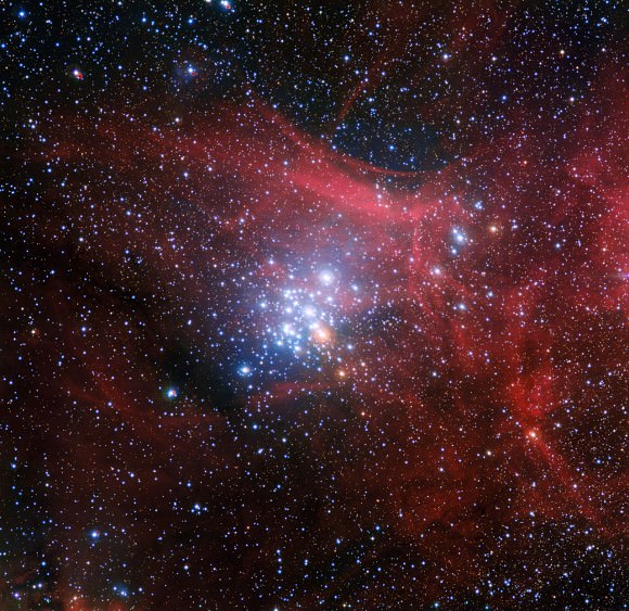 In this image from the Wide Field Imager on the MPG/ESO 2.2-metre telescope at ESO’s La Silla Observatory in Chile young stars huddle together against a backdrop of clouds of glowing gas and lanes of dust. The star cluster, known as NGC 3293, would have been just a cloud of gas and dust itself about ten million years ago, but as stars began to form it became the bright group we see here. Clusters like this are celestial laboratories that allow astronomers to learn more about how stars evolve. Image Credit: ESO/G. Beccari