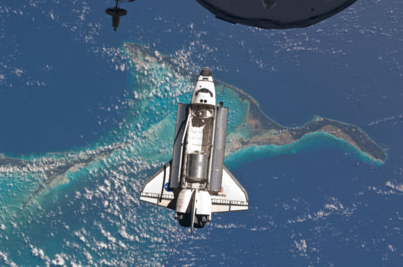 Space shuttle Atlantis gets ready to dock with the International Space Station on July 10, 2011 during STS-135, the last mission of the space shuttle program. It is backdropped by the Bahamas. Credit: NASA