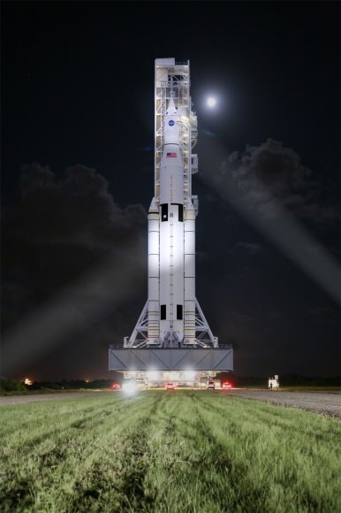 This artist concept shows NASA’s Space Launch System, or SLS, rolling to a launch pad at Kennedy Space Center at night. SLS will be the most powerful rocket in history, and the flexible, evolvable design of this advanced, heavy-lift launch vehicle will meet a variety of crew and cargo mission needs.   Credit:  NASA/MSFC