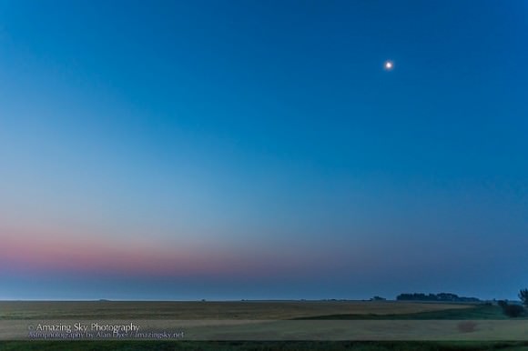 Venus and Jupiter 1/2 degree apart low in the pink twilight at lower left, with the waning crescent Moon near Aldebaran at upper right, taken from Alberta Canada on August 18, 2014 at dawn, looking due east. This is a single 1 second exposure at f/4 with the 16-35mm lens and Canon 6D at ISO 800. Credit and copyright: Alan Dyer/Amazing Sky Photography. 