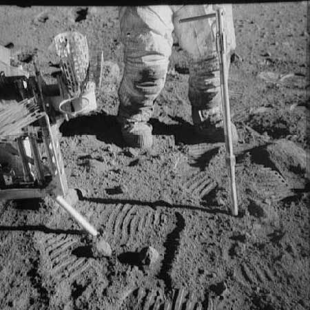 Footprints, dusty spacesuit knees and tools -- all a part of the Apollo 12 mission in November 1969. Credit: NASA / Lunar and Planetary Institute