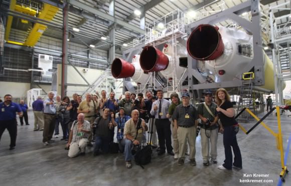 Space journalists including Ken Kremer/Universe Today pose with the Delta IV Heavy rocket resting horizontally in ULA’s HIF processing facility at Cape Canaveral that will launch NASA’s maiden Orion on the EFT-1 mission in December 2014 from Launch Complex 37.   Credit: Ken Kremer/kenkremer.com