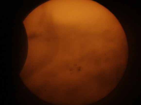 A cloudy closeup of the partial solar eclipse on October 23, 2014. Credit and copyright: JCC_Starguy on Flickr. 