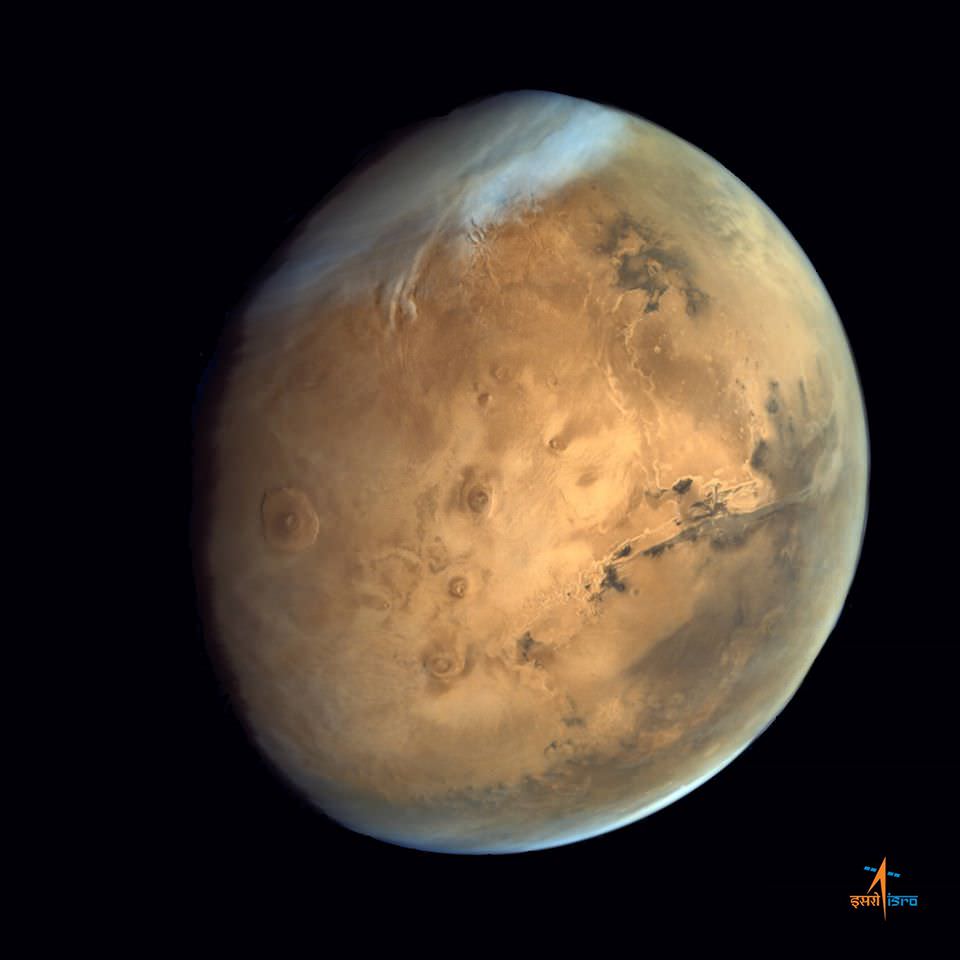 Olympus Mons, Tharsis Bulge trio of volcanoes and Valles Marineris from ISRO's Mars Orbiter Mission. Note the clouds and south polar ice cap.   Credit: ISRO
