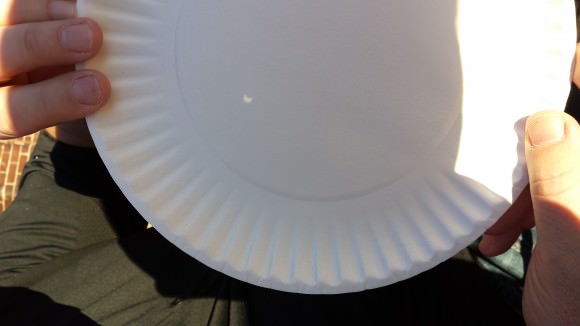 The partial solar eclipse as viewed through a paper plate pinhole projector. Credit, copyright and pinhole: Nancy Atkinson. 