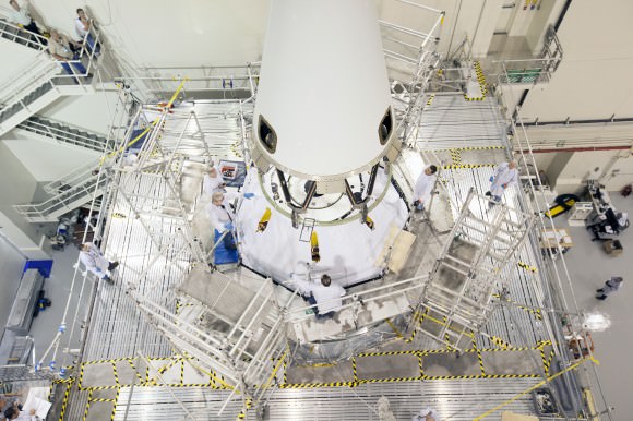 The launch abort system is lowered by crane for installation on the Orion spacecraft for Exploration Flight Test-1 inside the Launch Abort System Facility, or LASF, at NASA's Kennedy Space Center in Florida.   Photo credit: NASA/Cory Huston