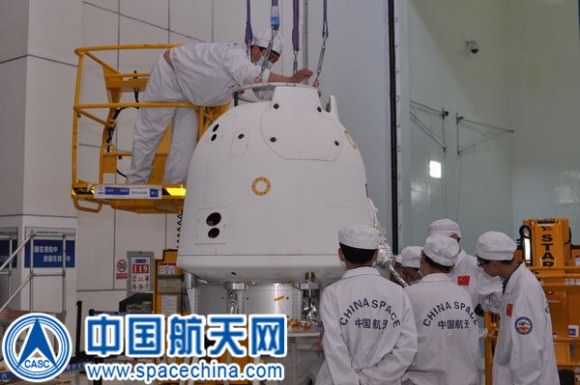 Technicians at work testing the  Chang'e-5T1 return capsule. Credit: Spacechina.com