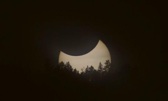 Solar eclipse over the Flatirons near Boulder, Colorado.  A syzygy, with the Earth and Moon simultaneously transiting the Sun. Credit and copyright: Alex Parker. 