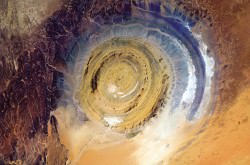 The Richat Structure in Mauritania, also known as the Eye of the Sahara, is a landmark for astronauts. It’s hard to know where you are, especially if you’re over a vast 3,600,000-square-mile desert, but this bull’s-eye orients you, instantly. Oddly, it appears not to be the scar of a meteorite but a deeply eroded dome, with a rainbow-inspired color scheme. Image Credit: Chris Hadfield / NASA