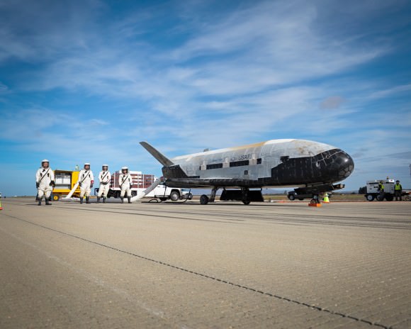 Recovery crew members process the X-37B Orbital Test Vehicle at Vandenberg Air Force Base after completing 674 days in space. A total of three X-37B missions have been completed, totaling 1,367 days on orbit.   Photo: Boeing
