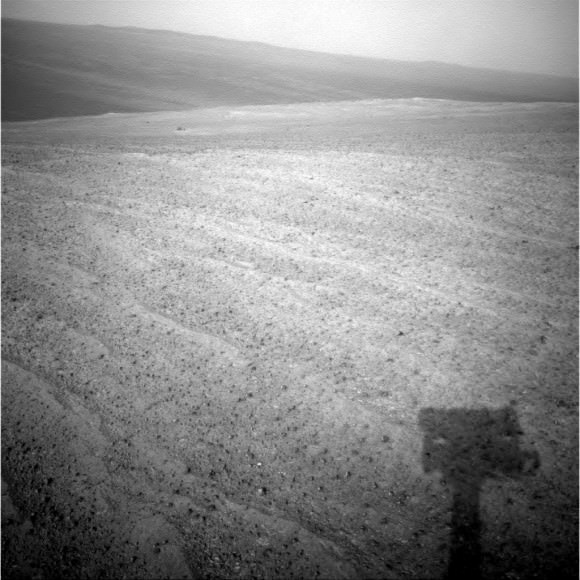 The shadow of the Opportunity rover (bottom) lies dark against Mars ground on Sol 3,841 in November 2014. Credit: NASA/JPL-Caltech/Cornell Univ./Arizona State Univ. 
