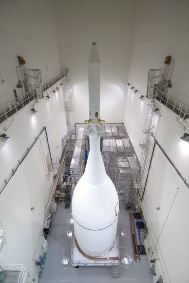 The Orion spacecraft sits inside the Launch Abort System Facility at NASA's Kennedy Space Center in Florida. The Ogive panels have been installed around the launch abort system.  Credit: NASA/Jim Grossman