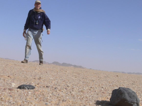 On Feb. 28, 2009, Peter Jenniskens (SETI/NASA), finds his first 2008TC3 meteorite after an 18-mile long journey. "It was an incredible feeling," Jenniskens said. The African Nubian Desert meteorite of Oct 7, 2008 was the first asteroid whose impact with Earth was predicted while still in space approaching Earth. 2008TC3 and Chelyabinsk are part of the released data set. (Credit: NASA/SETI/P.Jenniskens)