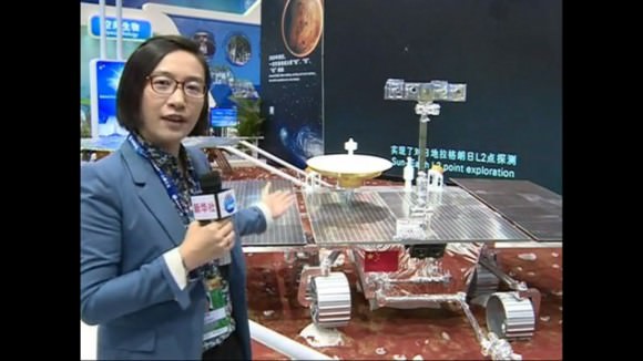 China View reporter Lai Yuchen is seen describing and pointing out the future Sino-Mars rover with plans for a 2020 launch coinciding with the NASA/JPL Mars 2020 rover mission . (Click still image for video Link) (Photo/Video Credit: China View)