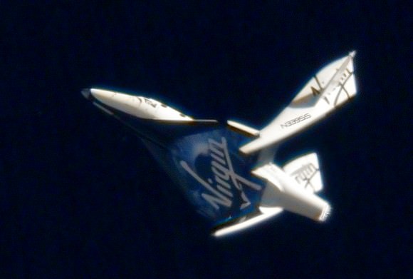 SpaceShipTwo is shown in the feathered configuration in an earlier unpowered test flight. While the test pilots tested the feathering in the lower, denser atmosphere, the vehicles was much slower and stresses on the vehicle remained well within safety margins. (Photo Credit: Virgin Galactic)