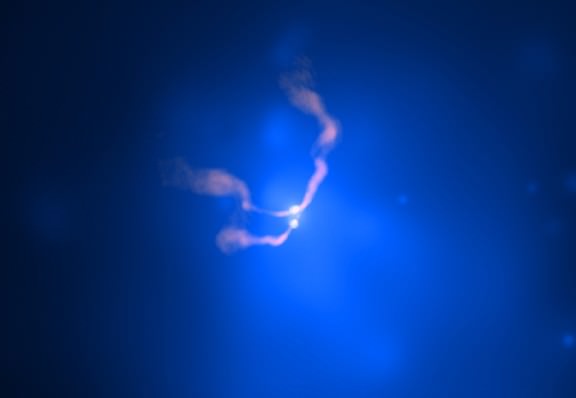 X-ray/radio composite image of two supermassive black holes spiral towards each other near the center of a galaxy cluster named Abell 400. Credit: X-ray: NASA/CXC/AIfA/D.Hudson & T.Reiprich et al.; Radio: NRAO/VLA/NRL