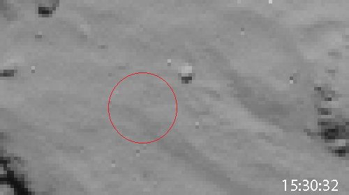 The animated image below provides strong evidence that Philae touched down for the first time almost precisely where intended. The animation comprises images recorded by Rosetta's navigation camera as the orbiter flew over the (intended) Philae landing site on November 12th. The dark area is probably dust raised by the craft on touchdown. The boulder to the right of the circle is seen in detail in the photo below. Credit: ESA/Rosetta/NAVCAM – CC BY-SA IGO 3.0