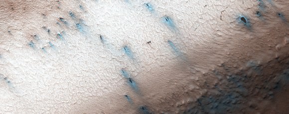 As of Sept. 6, 2014, fans in "Inca City" in the Martian southern hemisphere are now blue-gray. Why this color appears in the spring is unknown. It could be because of particles falling into ice underneath, or gas bursting from the ice condensing and falling as frost. It could even be a combination of the two. Image taken by the Mars Reconnaissance Orbiter's HiRISE orbiter. Credit: NASA/JPL/University of Arizona